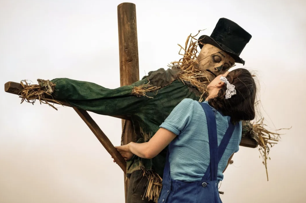 Mia Goth and a Scarecrow from "Pearl"